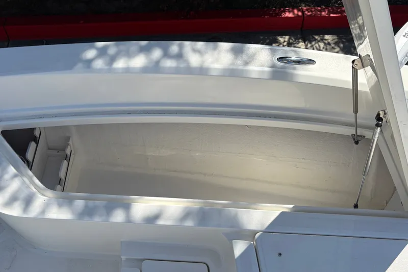 Slide: The Image of Open storage compartment on 2026 Mako 24 APEX boat, showcasing interior space. - 44