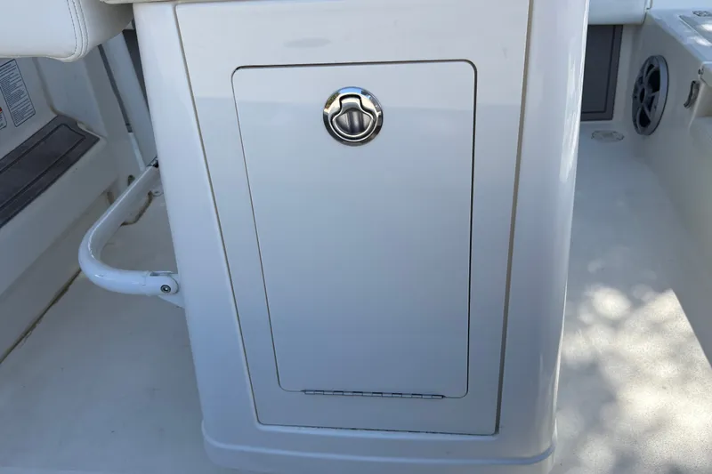 Slide: The Image of Storage compartment on a 2026 Mako 24 APEX boat, featuring a sleek white design. - 41