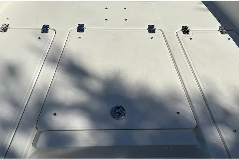 Slide: The Image of Hatch cover on 2026 Mako 24 APEX boat, featuring secure latches and sleek design. - 27
