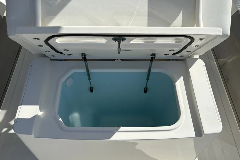 Slide: The Image of Open storage compartment on 2026 Mako 24 APEX boat, showcasing interior design. - 18