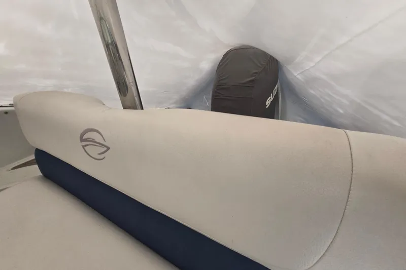 Slide: The Image of 2017 Crownline Eclipse E2 XS boat interior with cushioned seating and covered engine. - 11