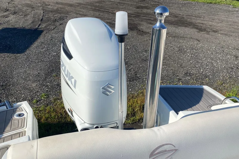 Slide: The Image of 2017 Crownline Eclipse E2 XS with Suzuki outboard motor, parked on asphalt. - 13