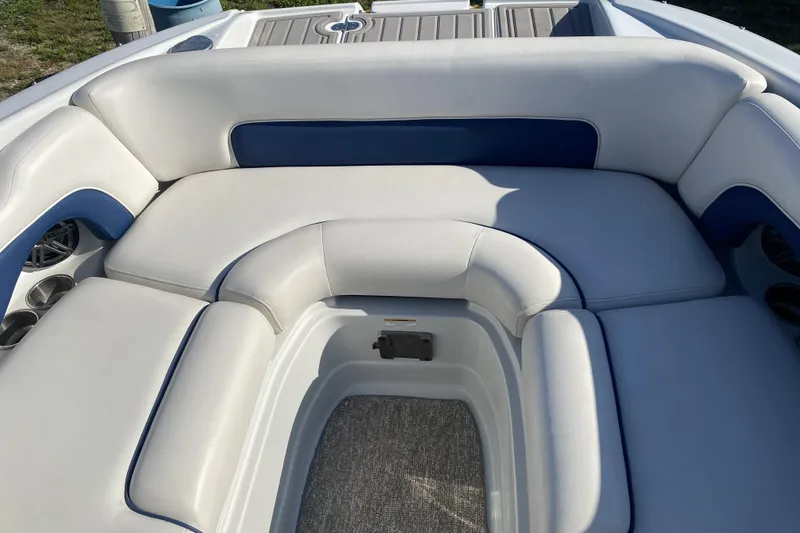 Slide: The Image of 2017 Crownline Eclipse E2 XS boat interior with white and blue cushioned seating. - 14