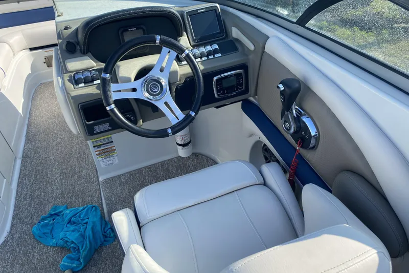 Slide: The Image of 2017 Crownline Eclipse E2 XS boat cockpit with steering wheel and controls. - 2