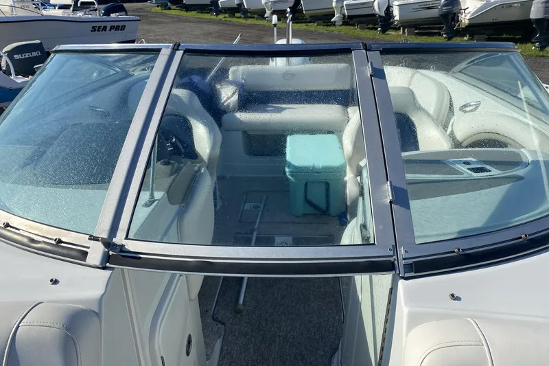 Slide: The Image of 2017 Crownline Eclipse E2 XS boat interior with seating and a cooler. - 7