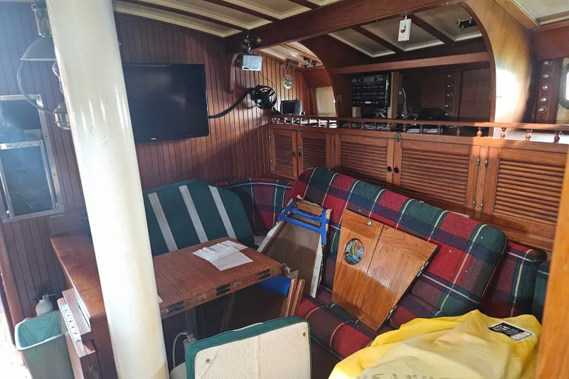 Slide: The Image of Interior of 1982 Kadey-Krogen 38 boat with wood paneling and plaid seating. - 18