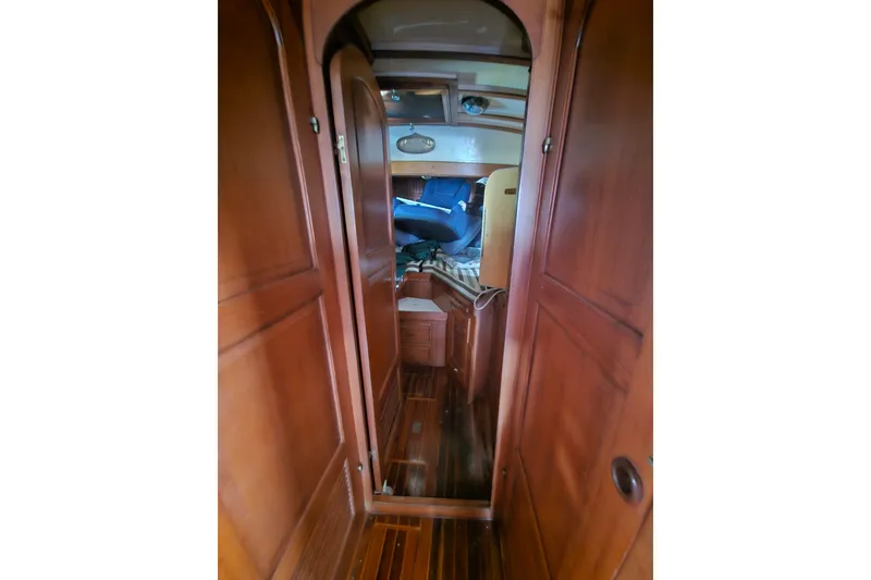 Slide: The Image of Interior view of 1982 Kadey-Krogen 38 yacht, featuring wooden cabinetry and cozy cabin space. - 32