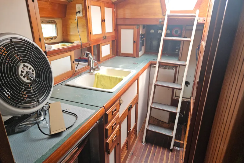 Slide: The Image of 1982 Kadey-Krogen 38 yacht interior with kitchen sink, fan, and ladder. - 9