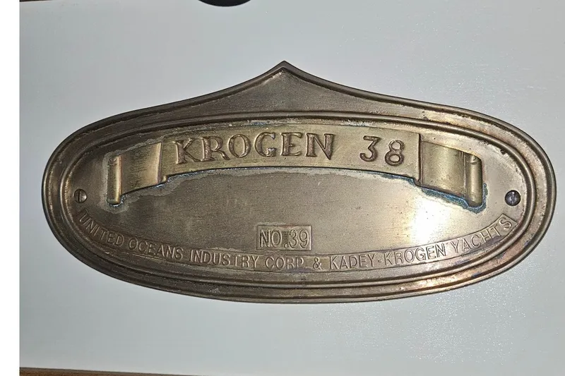 Slide: The Image of A bronze nameplate reading "Krogen 38" with manufacturing details. - 37