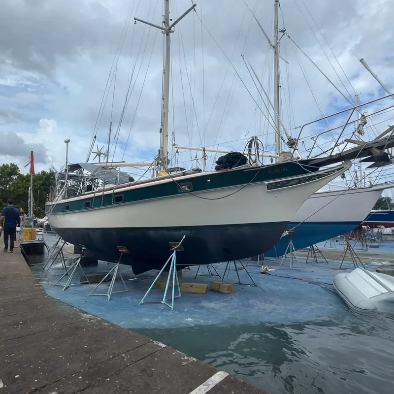 Slide: The Image of 1982 Kadey-Krogen 38 Dual Centerboard sailboat on stands in a boatyard. - 0