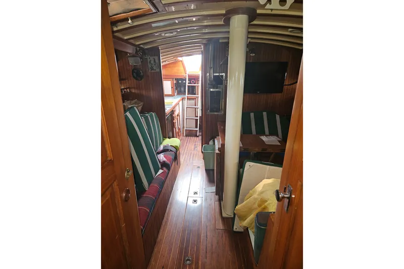 Slide: The Image of Interior of 1982 Kadey-Krogen 38 yacht with wood paneling and striped seating. - 19