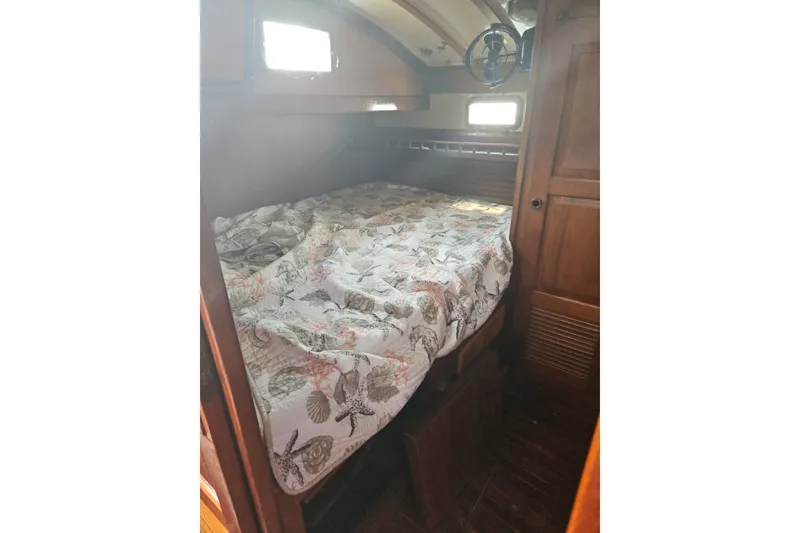 Slide: The Image of Cozy cabin interior of 1982 Kadey-Krogen 38 with nautical-themed bedding. - 16