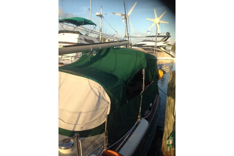 Slide: The Image of 1982 Kadey-Krogen 38 Dual Centerboard sailboat docked with green canopy cover. - 11