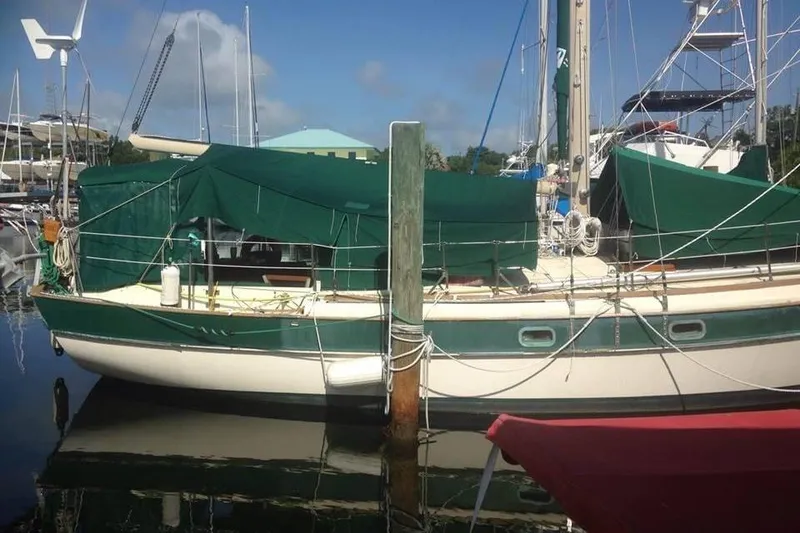 Slide: The Image of 1982 Kadey-Krogen 38 Dual Centerboard sailboat docked with green covers. - 14