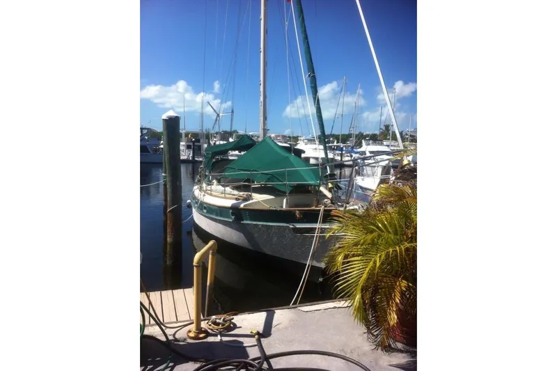 Slide: The Image of 1982 Kadey-Krogen 38 Dual Centerboard sailboat docked at a sunny marina. - 15
