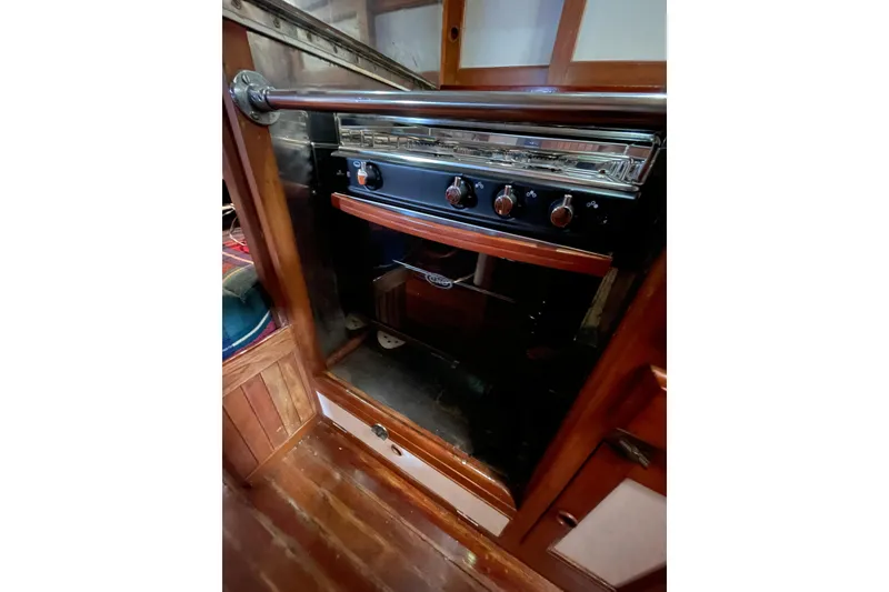 Slide: The Image of 1982 Kadey-Krogen 38 Dual Centerboard yacht kitchen with a classic stove and wooden cabinetry. - 17