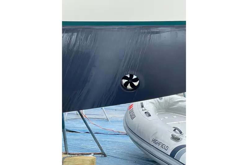 Slide: The Image of 1982 Kadey-Krogen 38 Dual Centerboard hull with visible thruster and inflatable boat nearby. - 28