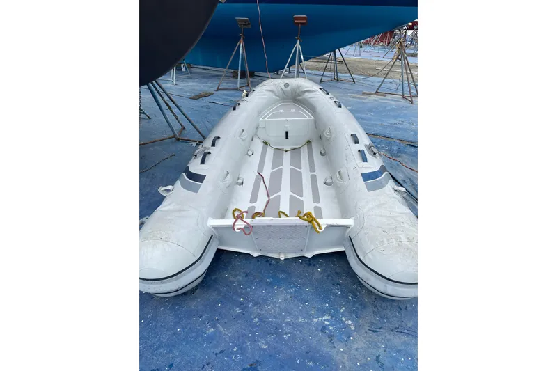 Slide: The Image of Inflatable boat on blue surface near 1982 Kadey-Krogen 38 Dual Centerboard yacht. - 29