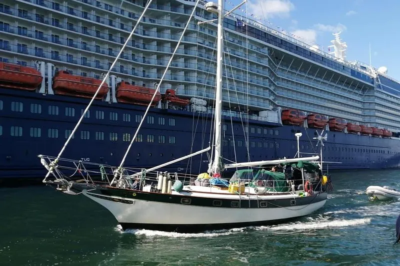 Slide: The Image of Sailboat Kadey-Krogen 38 Dual Centerboard 1982 cruising near a large cruise ship. - 3