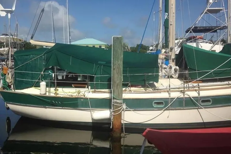 Slide: The Image of 1982 Kadey-Krogen 38 Dual Centerboard sailboat docked with green covers. - 4