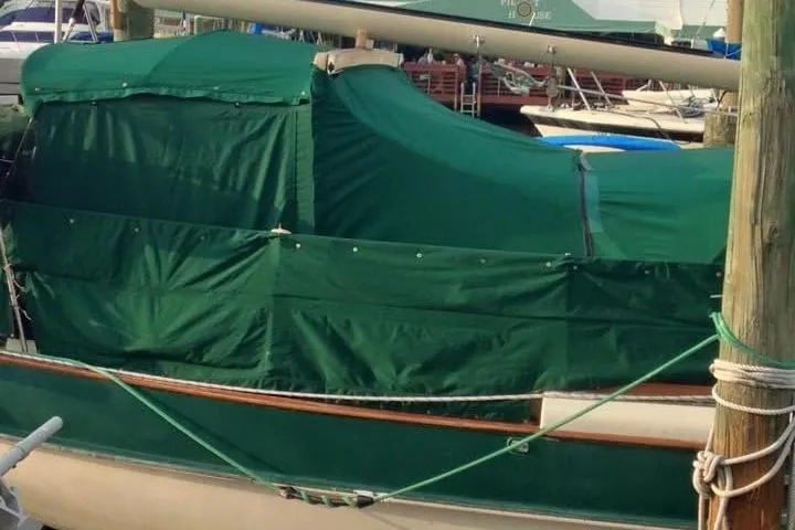 Slide: The Image of Kadey-Krogen 38 Dual Centerboard sailboat, 1982 model, docked with green covers. - 5