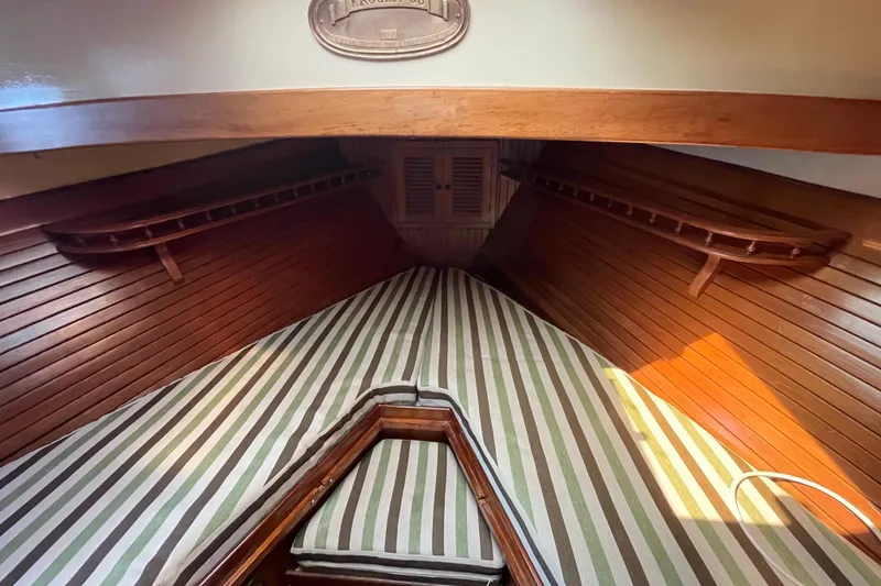 Slide: The Image of Interior of 1982 Kadey-Krogen 38 Dual Centerboard with striped cushions and wooden paneling. - 7