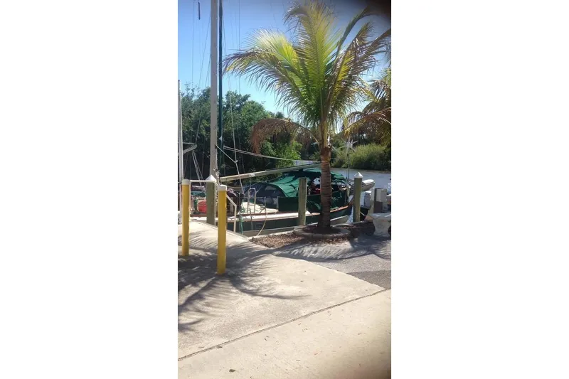 Slide: The Image of 1982 Kadey-Krogen 38 Dual Centerboard sailboat docked near palm tree. - 9
