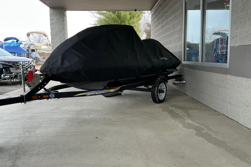 Slide: The Image of 2008 Yamaha WaveRunner FX Cruiser SHO covered on a trailer, parked near a building. - 11