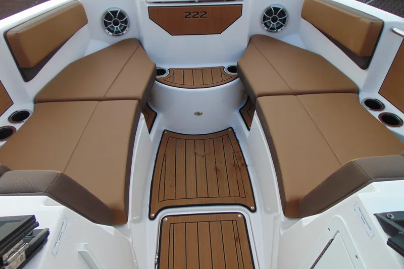 Slide: The Image of 2024 Yamaha Boats 222SD interior with brown seating and teak-style flooring. - 11