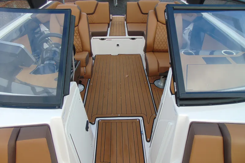 Slide: The Image of 2024 Yamaha Boats 222SD interior with brown seating and sleek design. - 12