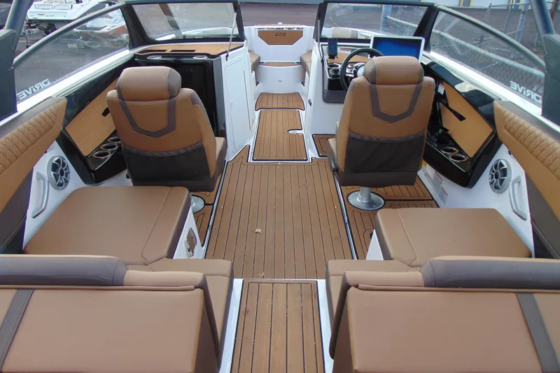 Slide: The Image of 2024 Yamaha Boats 222SD interior with brown seating and wood-style flooring. - 5