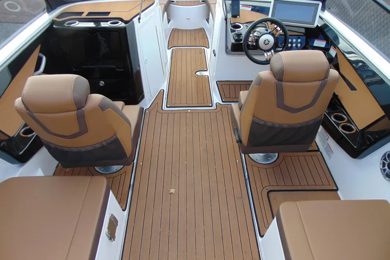 Slide: The Image of 2024 Yamaha Boats 222SD interior with brown seating and sleek dashboard design. - 6