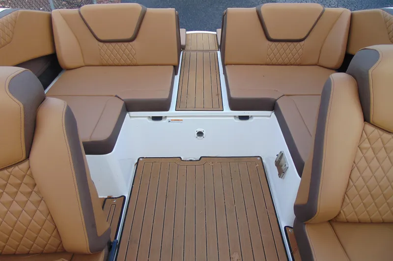 Slide: The Image of 2024 Yamaha Boats 222SD interior with tan leather seating and wood-style flooring. - 9