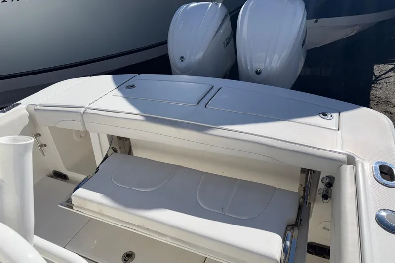 Slide: The Image of 2023 Regulator 28 boat with dual Yamaha engines, featuring a sleek white deck design. - 11