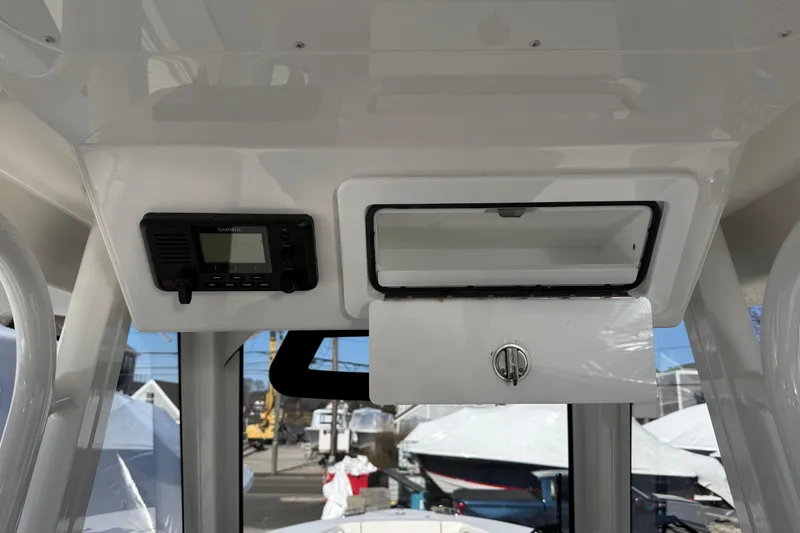 Slide: The Image of 2023 Regulator 28 boat console with Garmin device and storage compartment. - 18