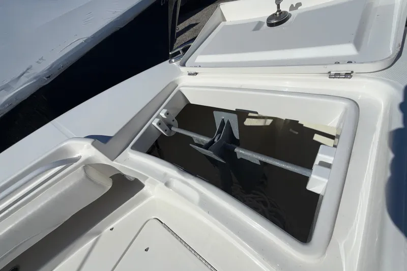 Slide: The Image of Open anchor compartment on 2023 Regulator 28 boat, showcasing storage space. - 19