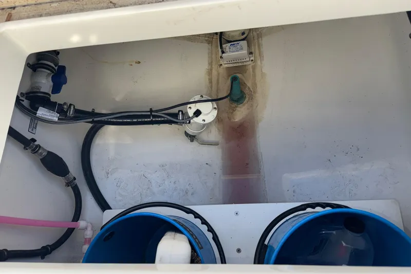 Slide: The Image of 2023 Regulator 28 boat interior showing plumbing and storage compartments. - 23