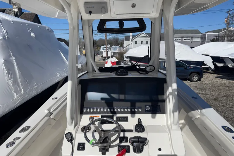 Slide: The Image of 2023 Regulator 28 boat cockpit with advanced navigation controls and steering wheel. - 3