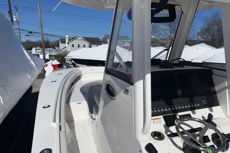 Slide: The Image of 2023 Regulator 28 boat interior with modern dashboard and steering wheel. - 4