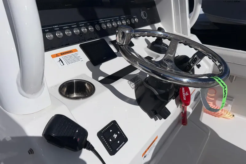 Slide: The Image of 2023 Regulator 28 boat dashboard with steering wheel and control panel. - 6