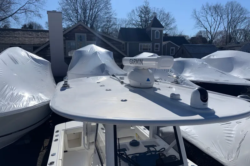 Slide: The Image of 2023 Regulator 28 boat with Garmin radar, docked among covered boats. - 7