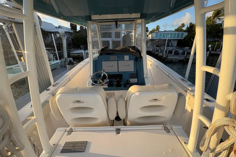 Slide: The Image of 2019 Cobia 320 Center Console boat interior with helm and seating. - 12