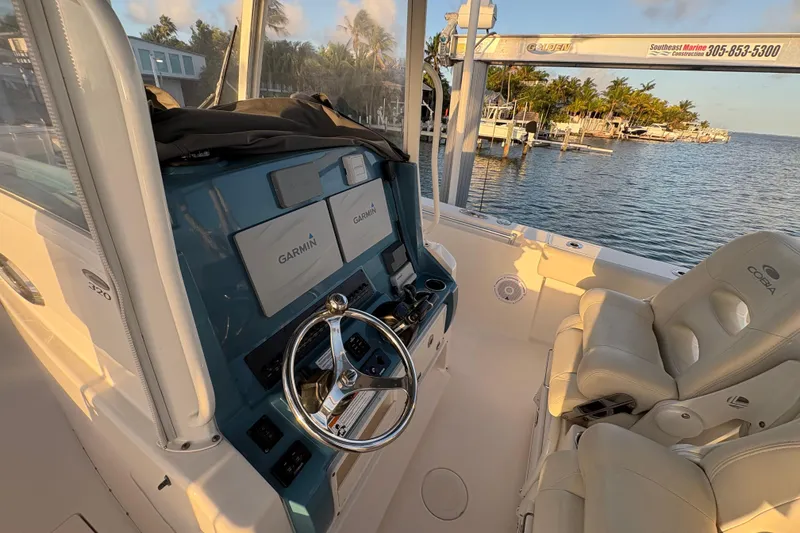 Slide: The Image of 2019 Cobia 320 Center Console boat interior with Garmin navigation system and comfortable seating. - 14