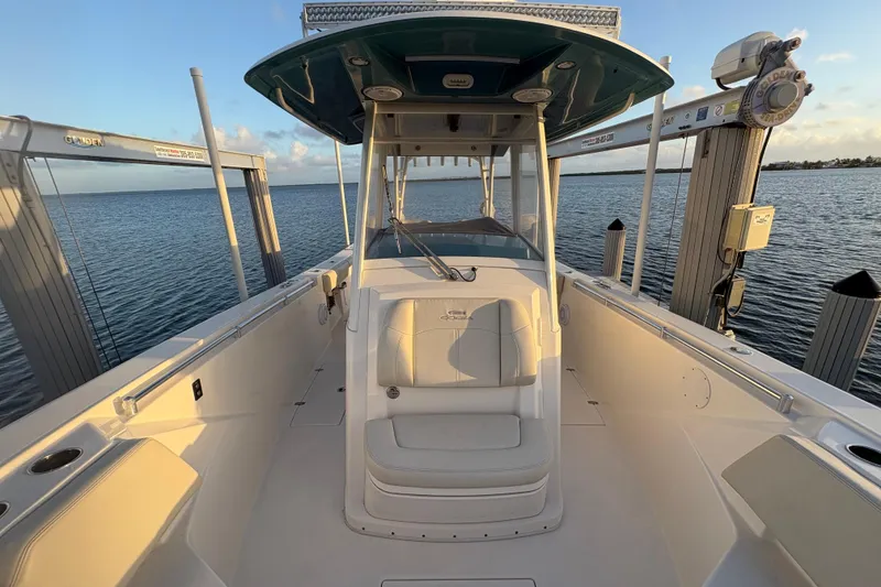 Slide: The Image of 2019 Cobia 320 Center Console boat docked, showcasing spacious deck and seating. - 17