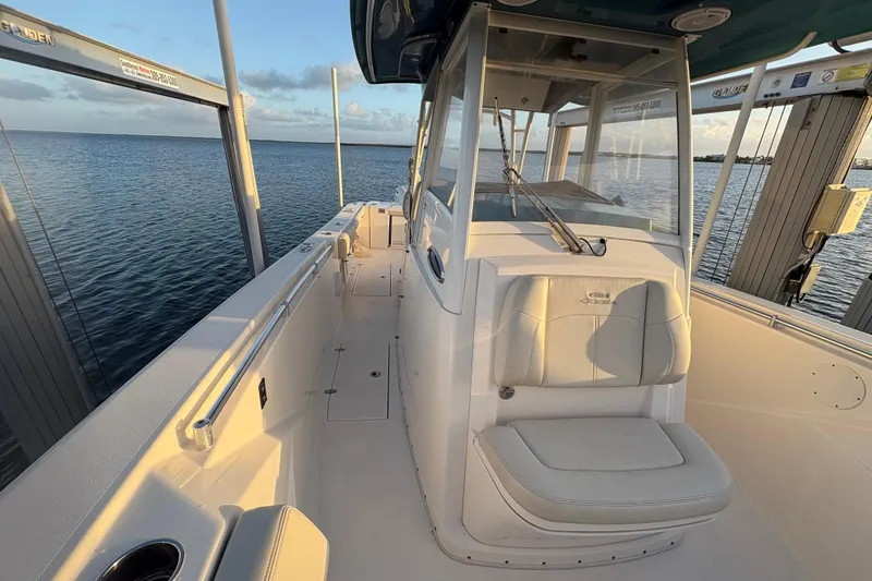 Slide: The Image of 2019 Cobia 320 Center Console boat on water, showcasing spacious deck and seating. - 21
