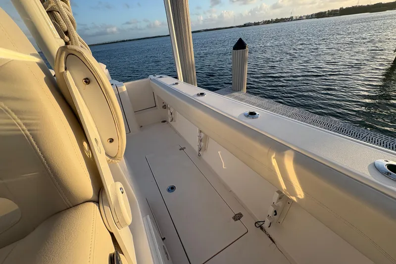 Slide: The Image of 2019 Cobia 320 Center Console boat interior with ocean view at sunset. - 24