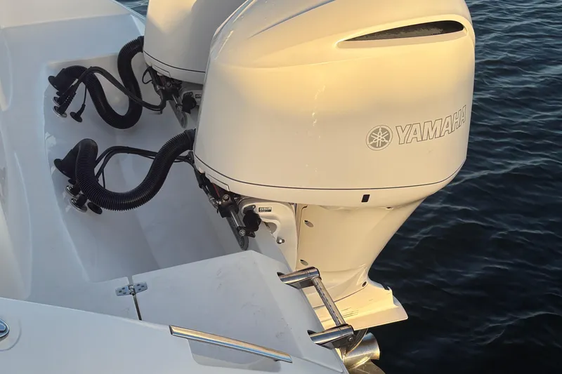 Slide: The Image of 2019 Cobia 320 Center Console with Yamaha outboard engines on water. - 6