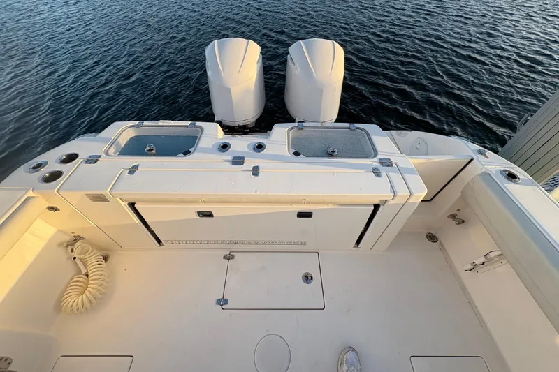 Slide: The Image of 2019 Cobia 320 Center Console boat deck with dual engines on water. - 7