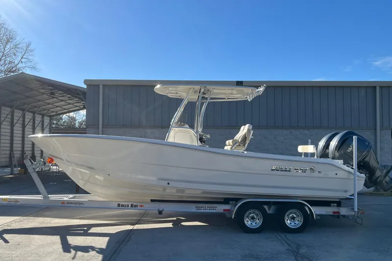 The Image of 2026 Bulls Bay 255 Center Console boat on trailer, parked outdoors under clear sky. - 0