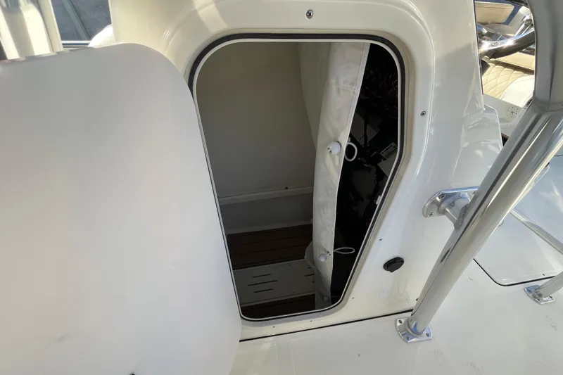 Slide: The Image of 2026 Bulls Bay 255 Center Console boat cabin entrance with open door. - 11